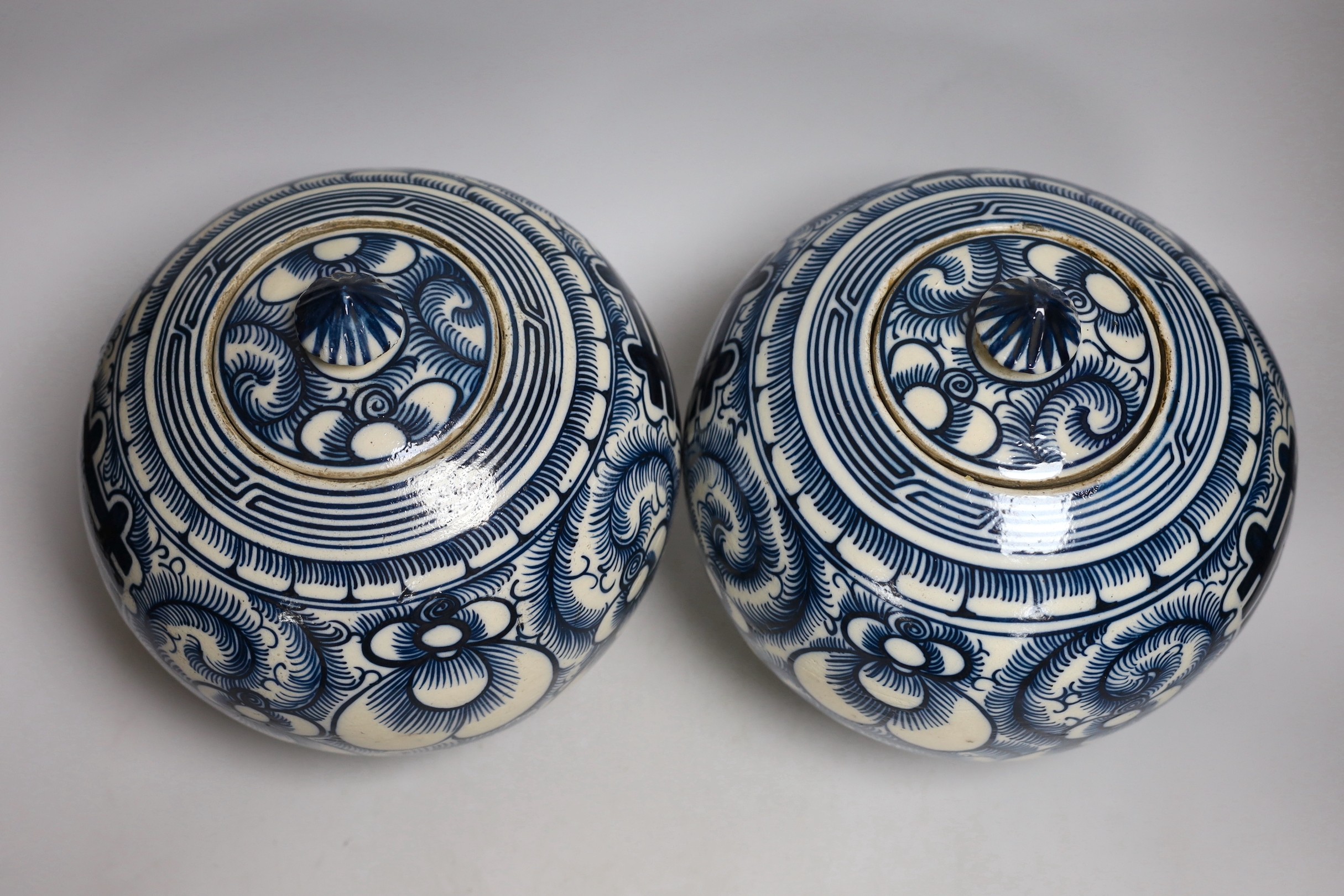 A pair of Chinese blue and white ‘Shuangxi’ jars and cover, 25cms high